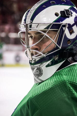Canes goaltender Pyotr Kochetkov (#52) eyeing a puck during warmups.