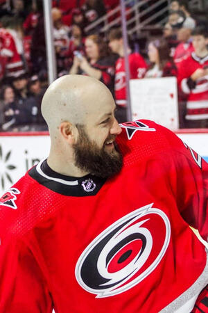 Canes foward Derek Stepan (#21) smiling at his kids during warmups.